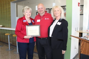 A former Norton School Graduate Student receiving an award