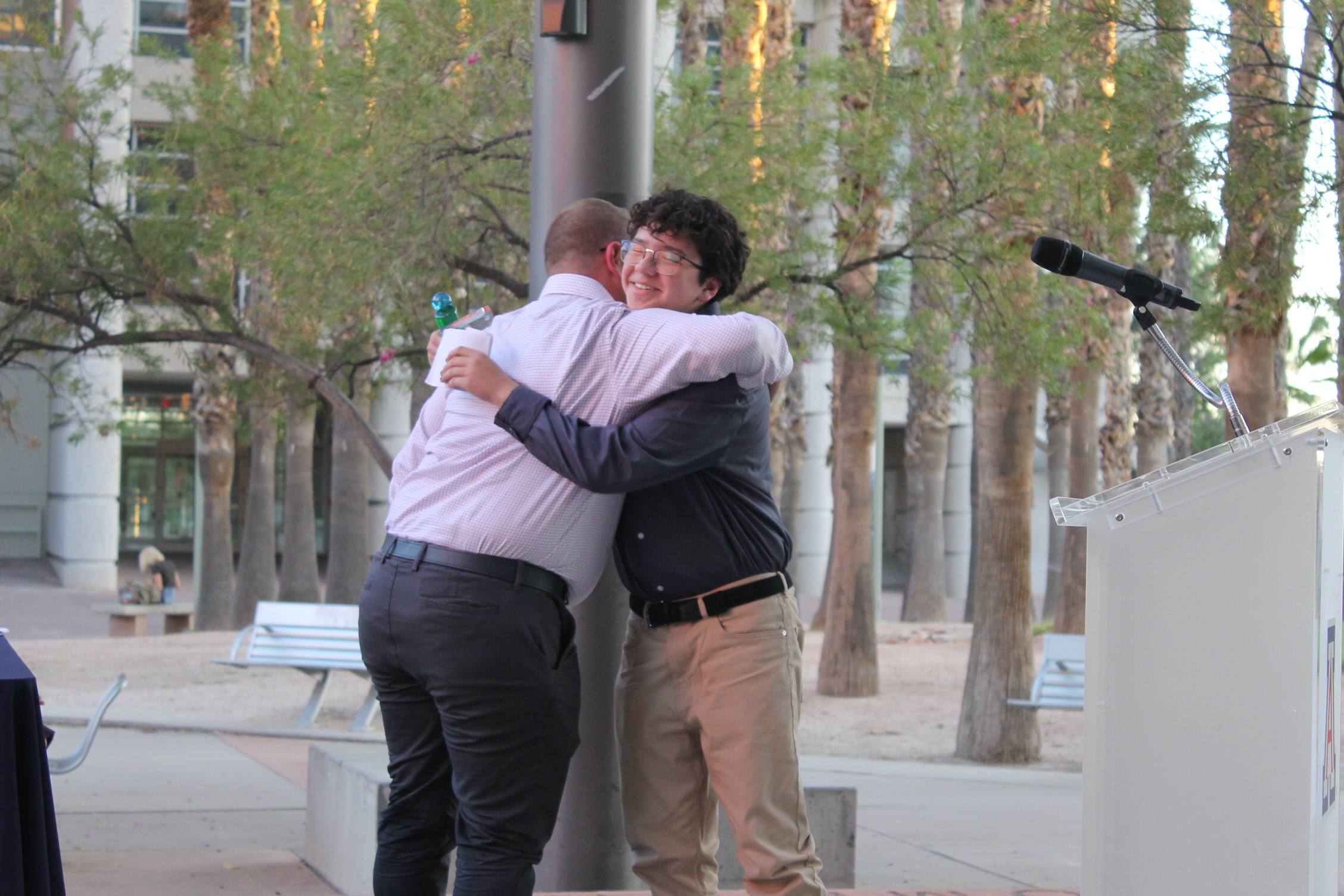 Russell Toomey hugs the Youth Vision Award Winner Daniel Trujillo