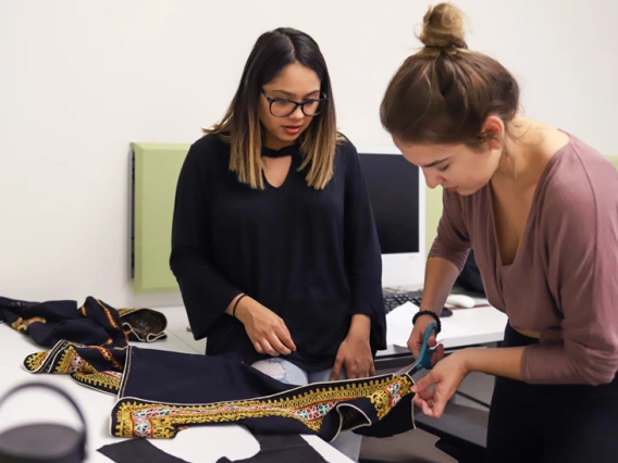 students cutting fabric