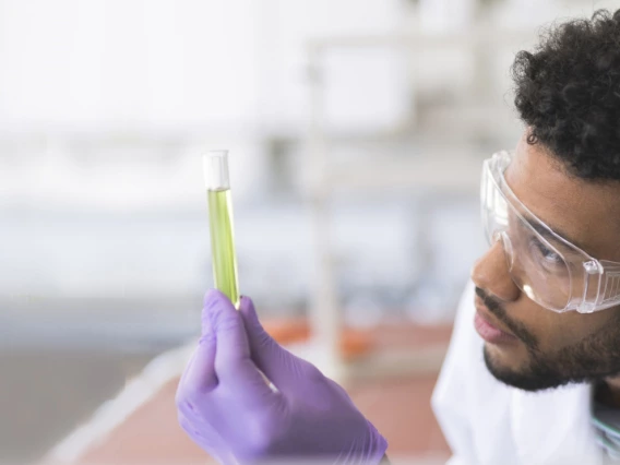 student observing a vial