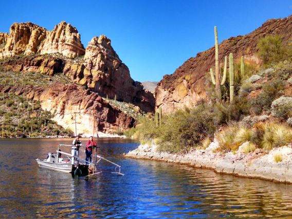 Graduate researchers in fish ecology a top a raft in an Arizona reservoir