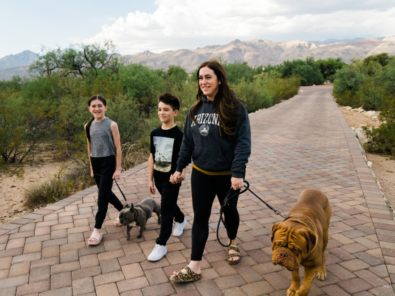 A mother walks her two children and two dogs in Tucson, Arizona