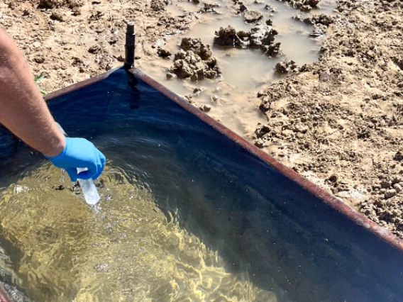 Environmental Science faculty Joseph Hoover takes a water sample during a previous community-led research project