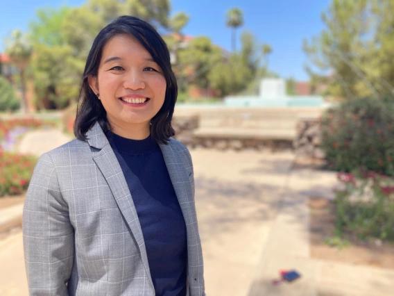 Na Zuo stands in front of Old Main on campus