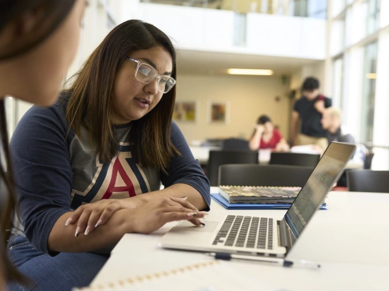 Students study in front of a laptop