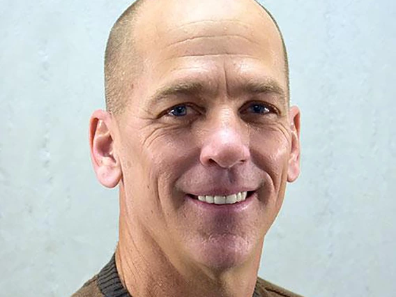 Ken Wilund poses in front of a gray background