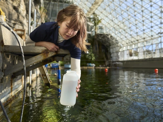 A researcher collecting water samples.