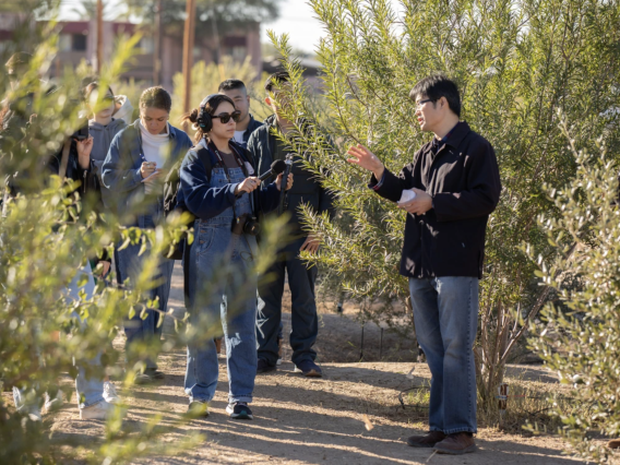 Picture of researcher Bo Yang talking to a member of the media