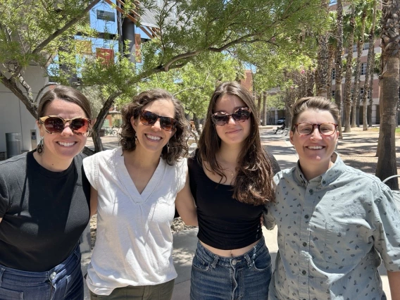 CRED staff members Rachel Leih, Madeleine deBois and Terrace Ewinghall pose with recent student Lily Juma.