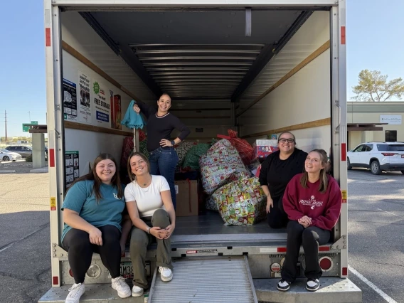 Tenley Higgins loading truck with Christmas gifts