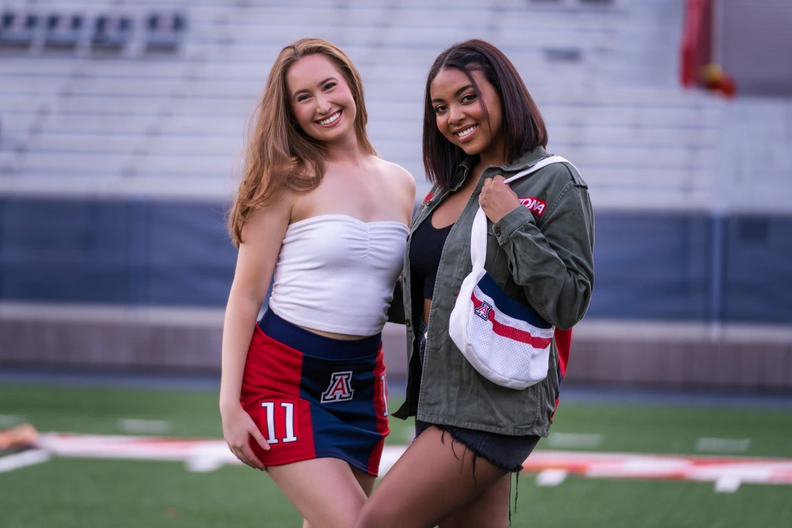University of Arizona undergraduate students Erika Gay (right) and Jade Butcher model clothing and accessories from the Arizona Replay clothing line, which incorporates retired UArizona football jerseys and thrifted clothing.
