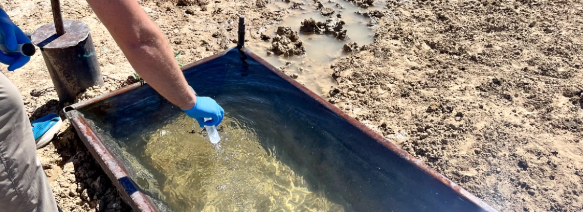 Environmental Science faculty Joseph Hoover takes a water sample during a previous community-led research project