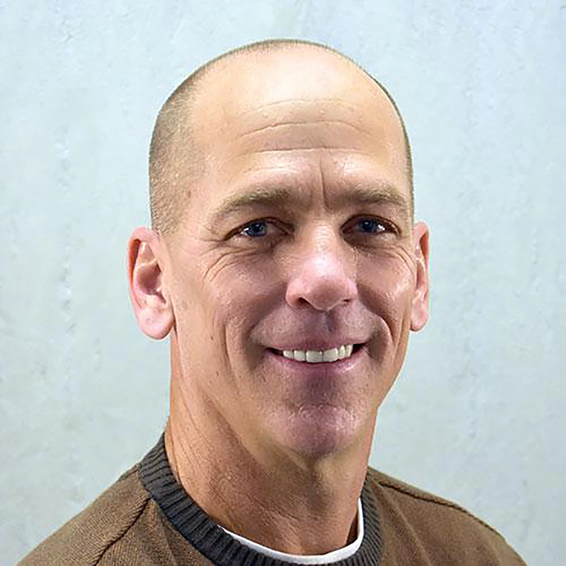 Ken Wilund poses in front of a gray background