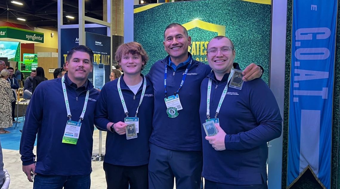 3 students from the university of arizona aeti program and frank santiago posing for a photo at the turf bowl