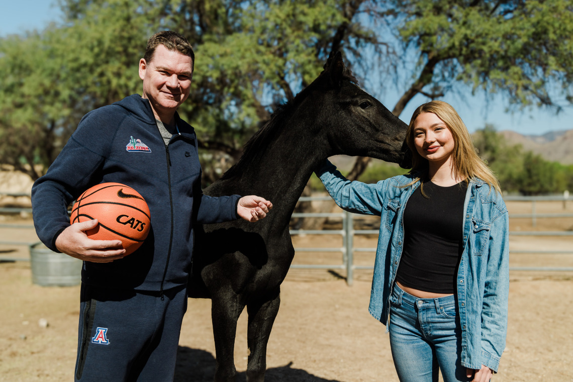 Picture of Coach Lloyd with weanling racehorse and his daughter