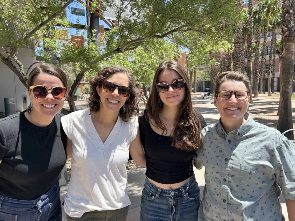CRED staff members Rachel Leih, Madeleine deBois and Terrace Ewinghall pose with recent student Lily Juma.