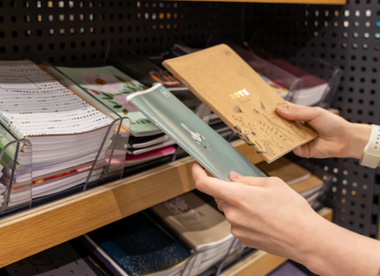 Shopper comparing two notebooks from a store's selection