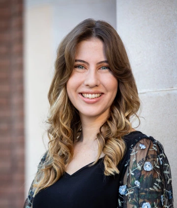 Cassandra Ott-Kocon, Experiential Learning Coordinator, standing in front of the Forbes Building on the University of Arizona campus