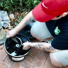 Graduate student and research team manager Bailey Payne checks a mosquito trap in midtown Tucson.