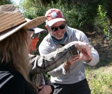 Michael Bogan and BIORETS participants catch a dragonfly in the field.