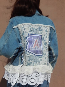 Bedazzled 'A' and lace jacket by Catalina Mascareño
