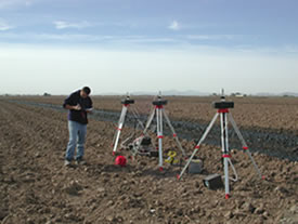 Student taking air samples in a field with applied biosolids
