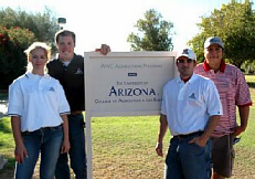 Students huddled together around the University of Arizona sign